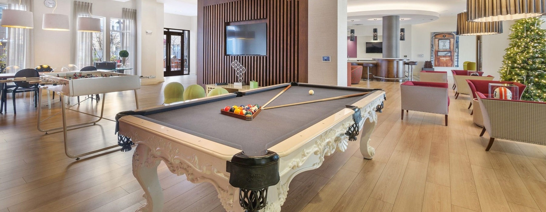 Well lit clubroom with pool table 