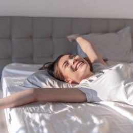 a girl waking up in bed